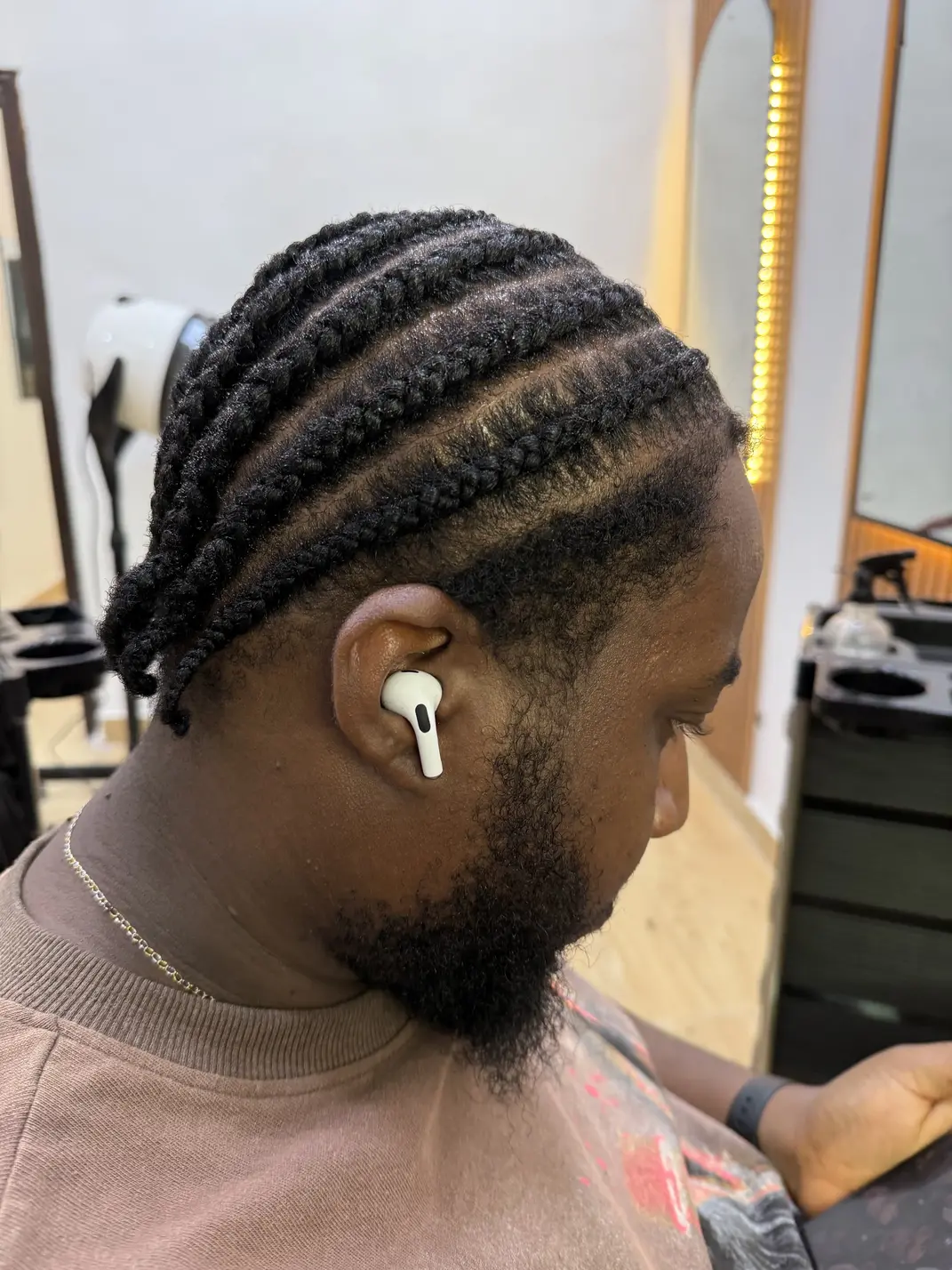 Client's finished cornrows, photographed in the Flourish Roots salon